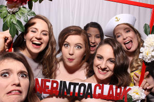 A bride and her bridesmaids in a FOTO Machines photobooth at a wedding