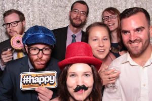 A group of friends in a FOTO Machines photobooth at a wedding