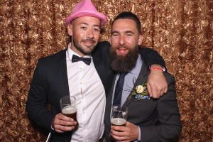 Two mates with beers in a FOTO Machines photobooth at a wedding